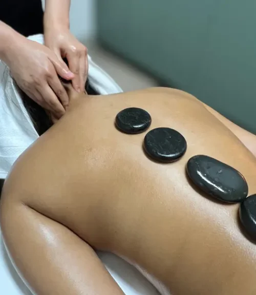 Parent sitting with shoulders and neck tension caused by chronic stress and caregiving responsibilities